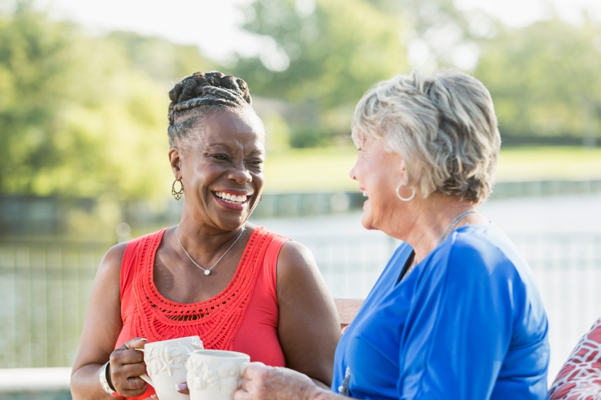 Two women enjoying each other's company. They are looking at each other, laughing